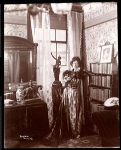 Anita Chartres standing in the corner of a room, c.1898 (silver gelatin print)